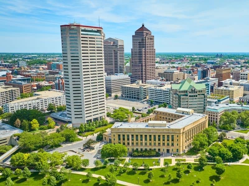 Downtown Columbus skyline with office buildings, green spaces, and urban landscape for Columbus land surveying services
