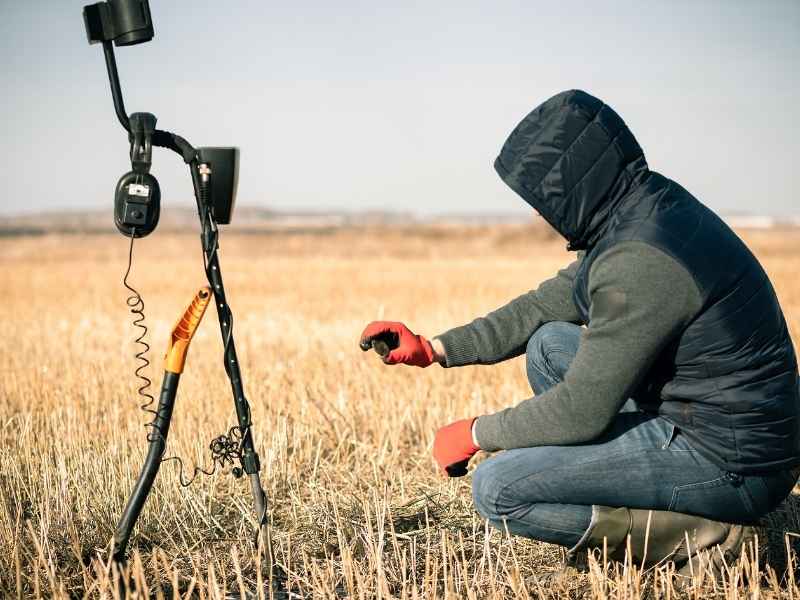 Surveyor searching for a missing property corner and buried boundary evidence in Columbus Georgia.